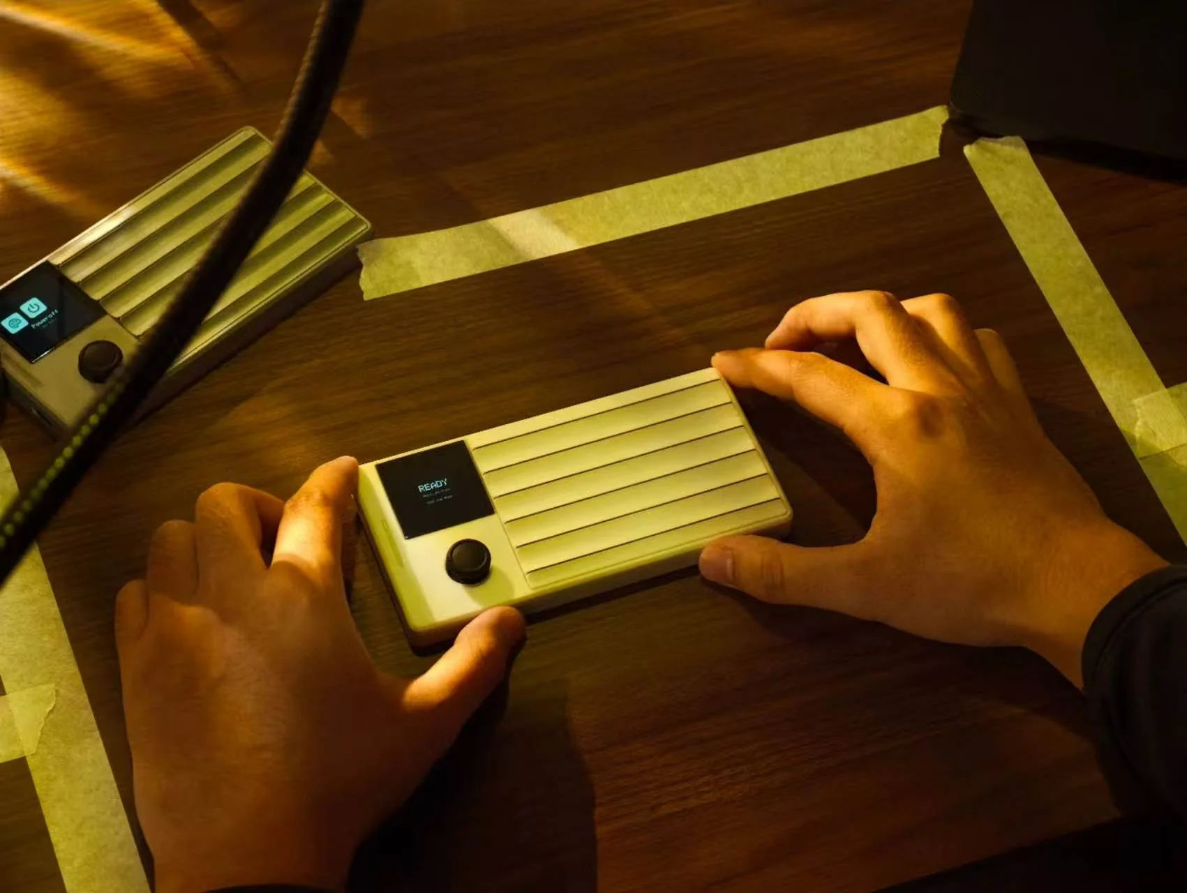 Pocket Guitar being played on a warm wooden table